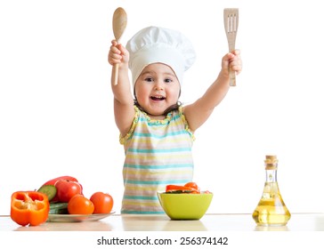 Smiling kid cook with ladle and kitchen spatula , isolated on white