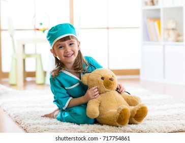 Smiling kid girl pretending she is a doctor in hospital