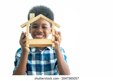 Smiling Kid Happy Holding Toy Wooden House, Real Estate, Housing And Family Concept. Isolated On White Background.