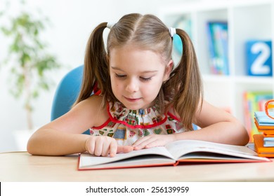 Smiling Kid Student Girl Reading Book In Children Room