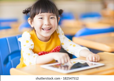 Smiling Kid Using Tablet  Or Ipad