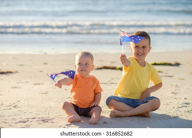 Smiling Kids With Flags Of Australia At The Beach