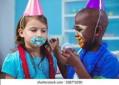 Smiling Kids With Icing On Their Faces At The Birthday Party