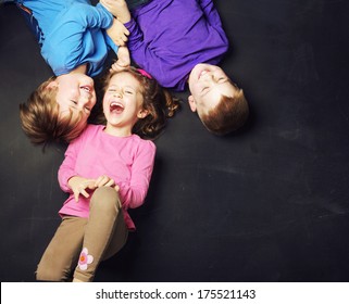 Smiling Kids On A Blackboard Background