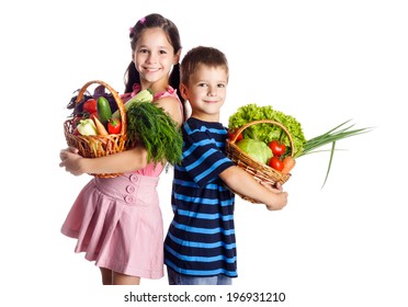 Smiling Kids Standing With Vegetables In Basket, Isolated On White