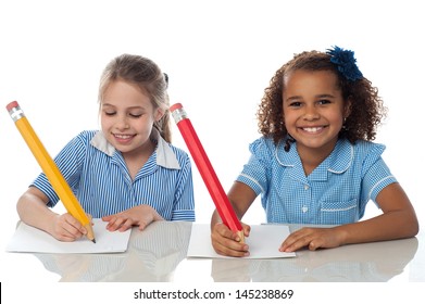 Smiling Kids Writing Their Annual Exam