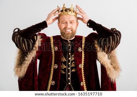 smiling king wearing crown on head isolated on grey