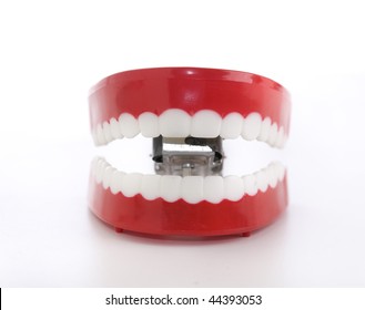 Smiling kitsch joke wind up chattering teeth and mouth