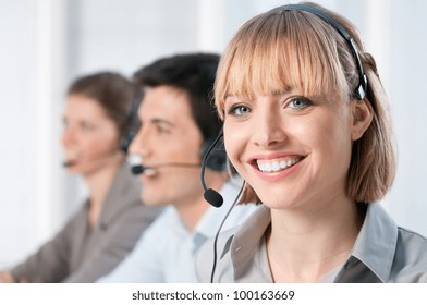 Smiling Lady Working At Call Center Office With Colleagues