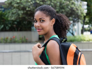 Smiling Latin Female Student With Bag In The City