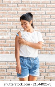 Smiling Latin Woman Looking At Her Shoulder After Being Vaccinated Against The Covid 19 Flu. Second Dose.