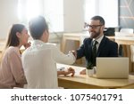 Smiling lawyer, realtor or financial advisor handshaking young couple thanking for advice, insurance broker or bank worker and millennial customers shake hands making deal, investment or taking loan