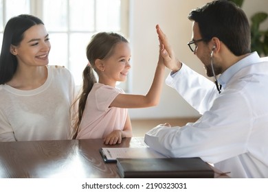 Smiling little 7s Caucasian girl patient give high five feel pleased at consultation with pediatrician in clinic. Caring male doctor cheer support small kid at checkup in hospital. Healthcare concept. - Powered by Shutterstock