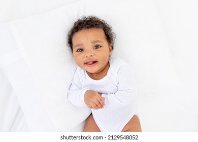 Smiling Little African American Baby In A Crib, Portrait