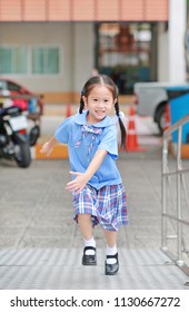 Smiling Little Asian Kid Girl In School Uniform Running Up Metal Stair.