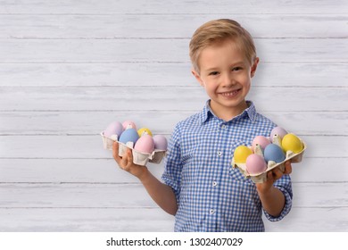 Smiling, little boy is holding Easter eggs.