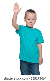 A smiling little boy stretching his right hand up on the white background