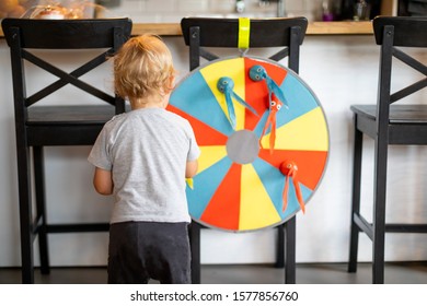 Smiling Little Child Boy Playing Toy Dart At Home