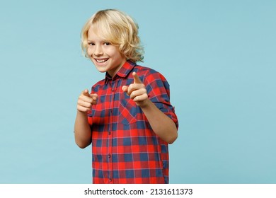 Smiling little curly kid boy 10s years old wearing basic red checkered shirt point index fingers camera on you isolated on blue color background children studio portrait. Childhood lifestyle concept - Shutterstock ID 2131611373