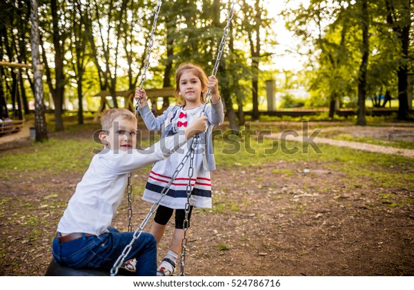 Smiling Little Girl Boy On Swing Stock Photo (Edit Now) 524786716