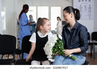 Smiling Little Girl Chatting With Mother In Medical Clinic Waiting Room. Happy Family Members Waiting To See Hospitalized Relative At Sanatorium. Visiting Room Of Busy Hospital.