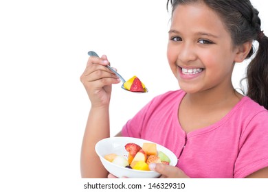 Smiling Little Girl Eating Fruit Salad On White Background