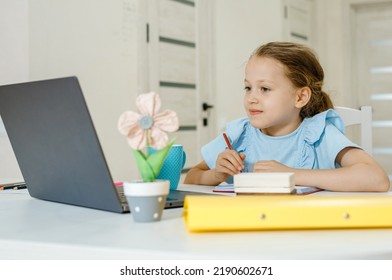 Smiling little  girl in  has video call in remote classroom with teacher using laptop, happy little kid greeting with tutor, learning online on computer, home learning concept - Shutterstock ID 2190602671