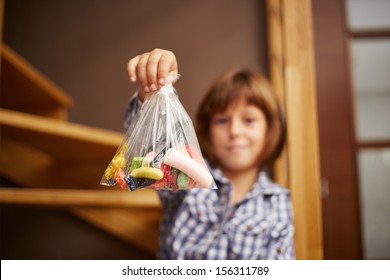 Smiling Little Girl Holding A Bag Of Candy