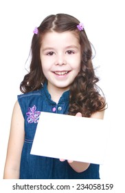 Smiling little girl holds up a white card on which you can write something ..Isolated on white background.