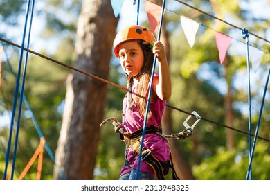 Smiling little girl on the playground, climbing rope net - Powered by Shutterstock