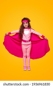 Smiling little girl in pink super hero outfit