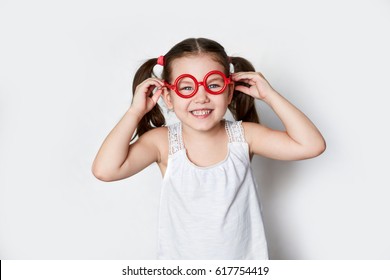 Smiling Little Girl In Red Toy Glasses