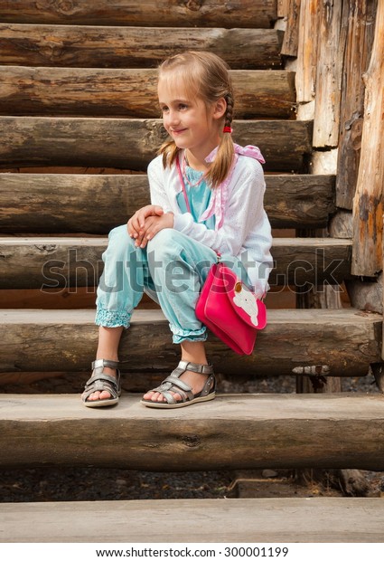 Smiling Little Girl Sitting On Log Stock Photo 300001199 | Shutterstock