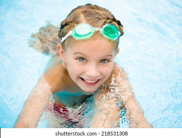 Smiling Little Girl In Swimming Pool