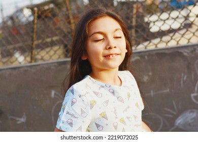 Smiling little latin girl with closed eyes. - Shutterstock ID 2219072025
