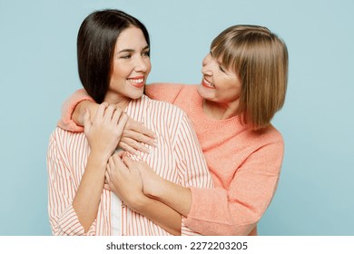 Smiling lovely fun elder parent mom with young adult daughter two women together wearing casual clothes hugging cuddle looking to each other isolated on plain blue cyan background. Family day concept - Shutterstock ID 2272203205