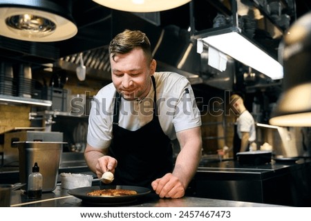 Similar – Image, Stock Photo Concentrated chef adding cream inside ceramic plate