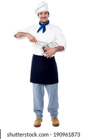 Smiling Male Chef Mixing Ingredients In A Bowl