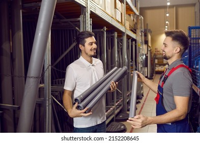 Smiling male consultant in building hypermarket consult client about pipes. Happy salesman or assistant help man customer with goods in construction store. Shop assistance and retail concept.