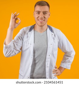 Smiling Male Doctor Showing Ok Sign On Yellow Background, Concept Everything Will Be Fine