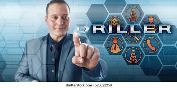 Smiling Male Oil Well Team Leader With Happy Facial Expression Touching DRILLER On A Virtual Control Screen. Oilfield Terminology And Petroleum Industry Concept For The Drilling Supervisor In Charge.