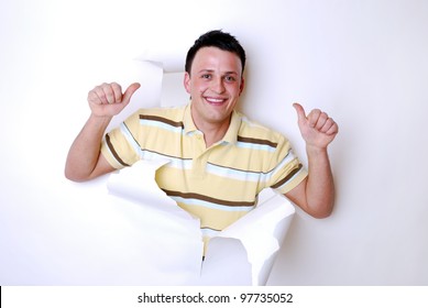 smiling man break through a paper wall