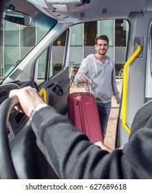 Smiling man, carrying a suitcase, entering a minivan, on his way to the airport, his eyes meeting and greeting the bus driver.