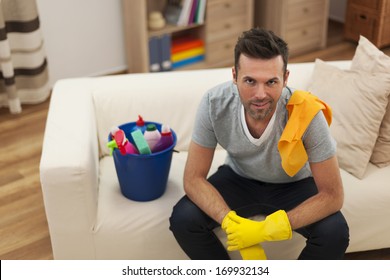 Smiling Man With Cleaning Equipment In Living Room