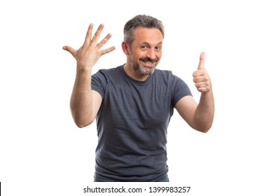 Smiling Man Counting By Holding Six Fingers Up As Sixth Concept Isolated On White Studio Background