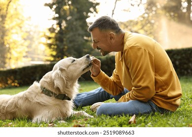 Smiling man with cute Golden Retriever dog on spring day - Powered by Shutterstock