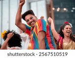 Smiling man dancing and celebrating Carnival in vibrant streets of Brazil. Cheerful adults enjoying the Carnaval parade with colorful clothes and joyful energy in urban festival