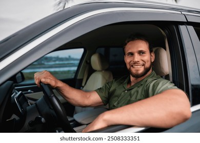 Smiling man driving a car with natural background and palm trees - Powered by Shutterstock