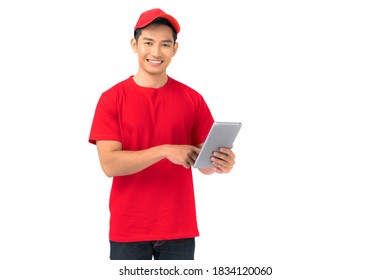 Smiling man employee in red cap blank t-shirt uniform standing with using digital tablet isolated on white background - Powered by Shutterstock