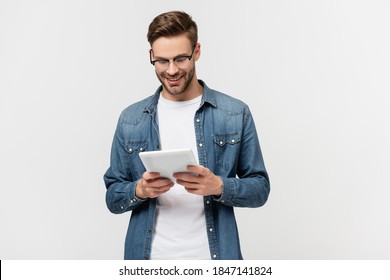 Smiling Man In Eyeglasses Holding Digital Tablet Isolated On Grey